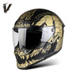 A black full-face motorcycle helmet with gold and black graphic designs and a clear visor.