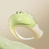 A light green adjustable baby bath shampoo shield cap with ear protection shown against a blurred green background.