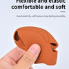 A hand is holding an orange silicone gear shift cover, demonstrating its flexible and soft texture.