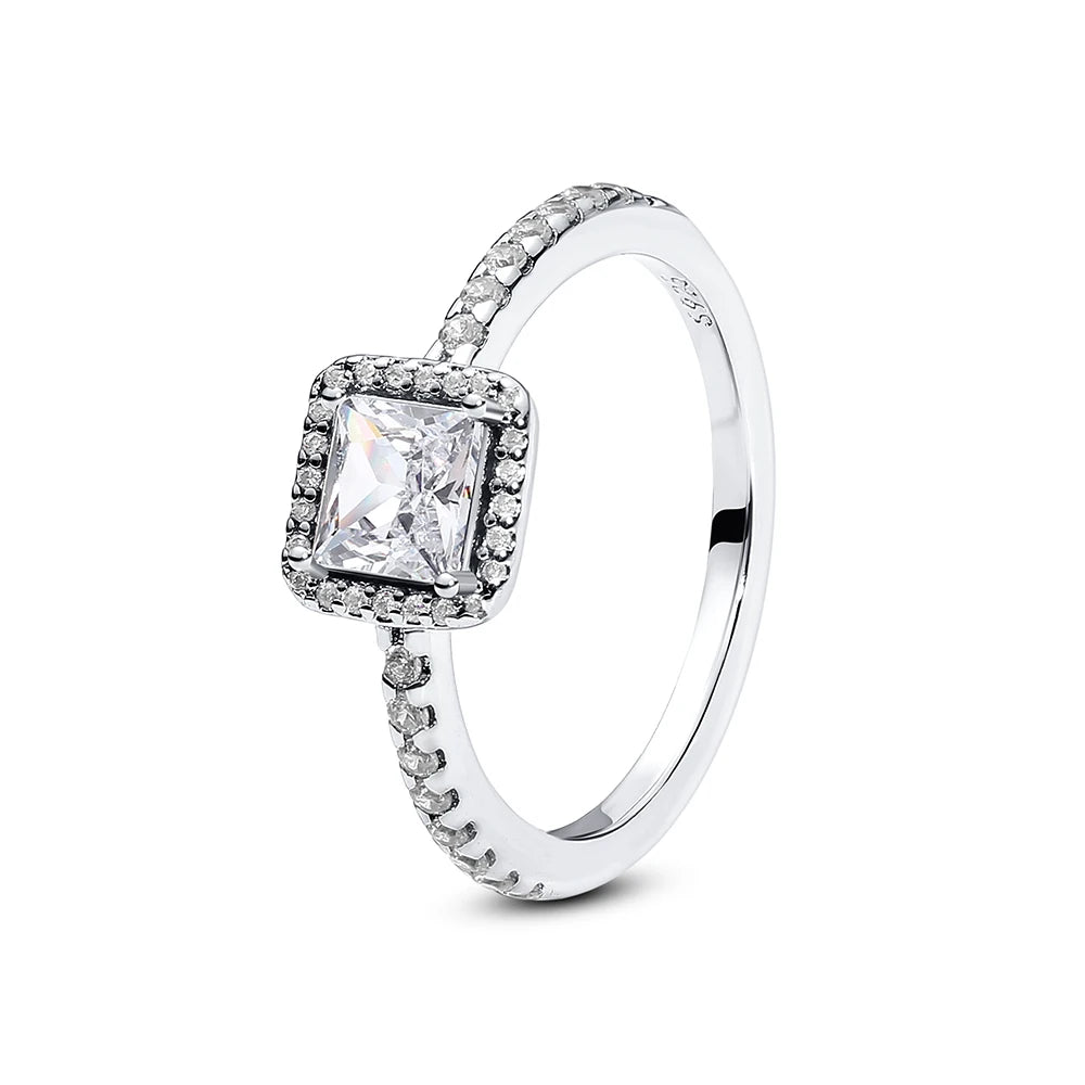 Sterling silver heart ring featuring a square diamond and surrounding pavé stones.