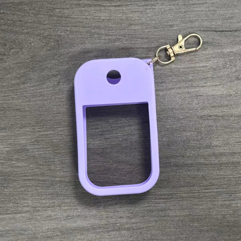 A purple silicone protective case for a hand sanitizer spray attached to a metal keyring.
