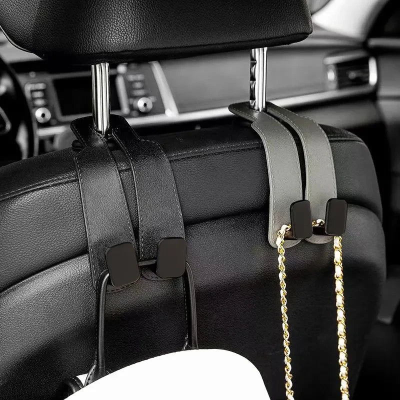 Black car headrest hooks designed to secure bags and shopping organizers