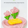 A pink tulip drainage soap dish with a yellow bar of soap is shown draining water.