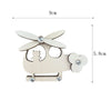 Wooden Montessori busy board parts set featuring a cutout of a flying animal and a small cat.
