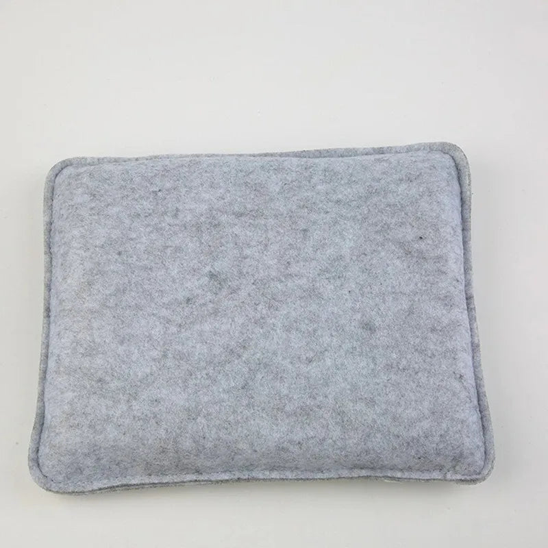 A square, gray felt mat used for wool crafting.