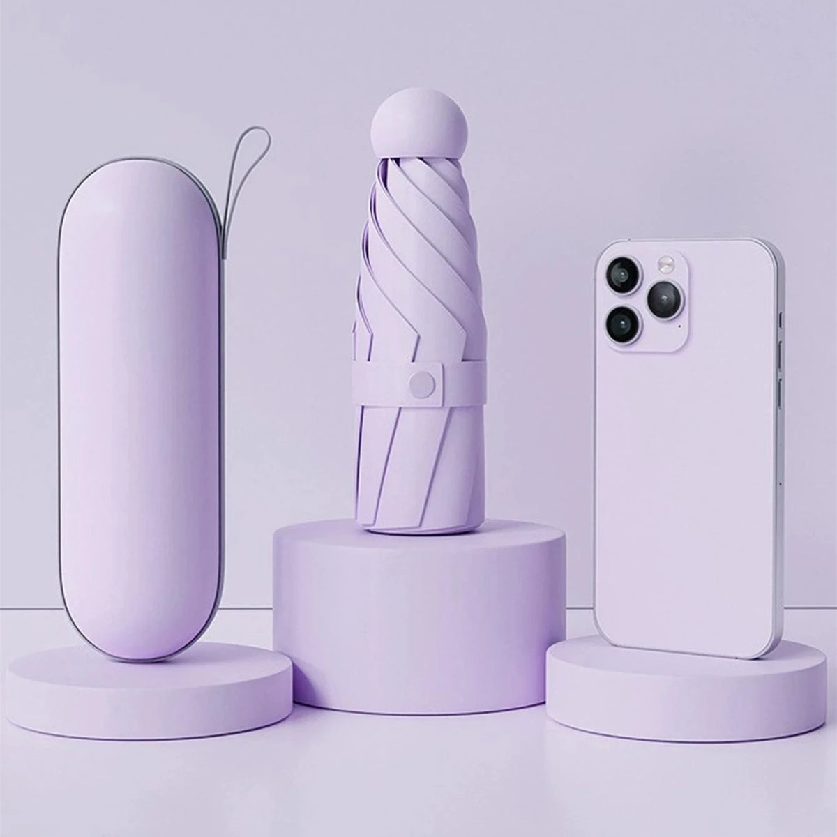 A purple compact folding umbrella is displayed next to a smartphone on a light purple surface.