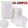 A stack of white padded bubble mailers with self-seal closures, showing the texture and quantity.