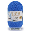 A ball of blue milk cotton blend yarn with a label featuring a dog and text in Chinese and English.