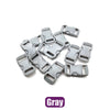 A collection of gray plastic side-release buckles for paracord bracelet projects.