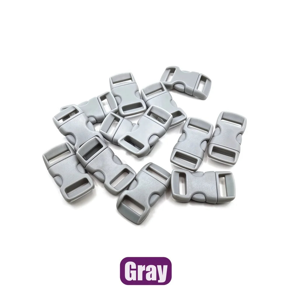 A collection of gray plastic side-release buckles for paracord bracelet projects.