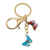 Gold-toned butterfly keychain charm with pink and blue accents