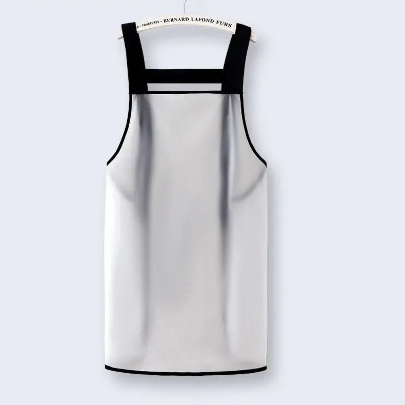 A white waterproof oil-proof kitchen apron with black straps hanging on a hanger.