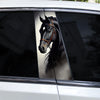 A close-up photo of a black horse's head with leather tack, displayed on a car window decal.
