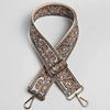 A beige and brown paisley jacquard strap with a gold-toned buckle and metal hardware.