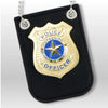 A black felt badge featuring a gold police officer seal with blue and white details and attached to a keyring.