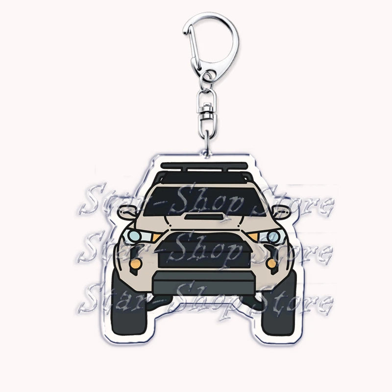 A silver metal keychain featuring a detailed silhouette of an off-road truck.