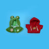 A set of green and red cloth apparel featuring an eiling robot design with embroidered details.