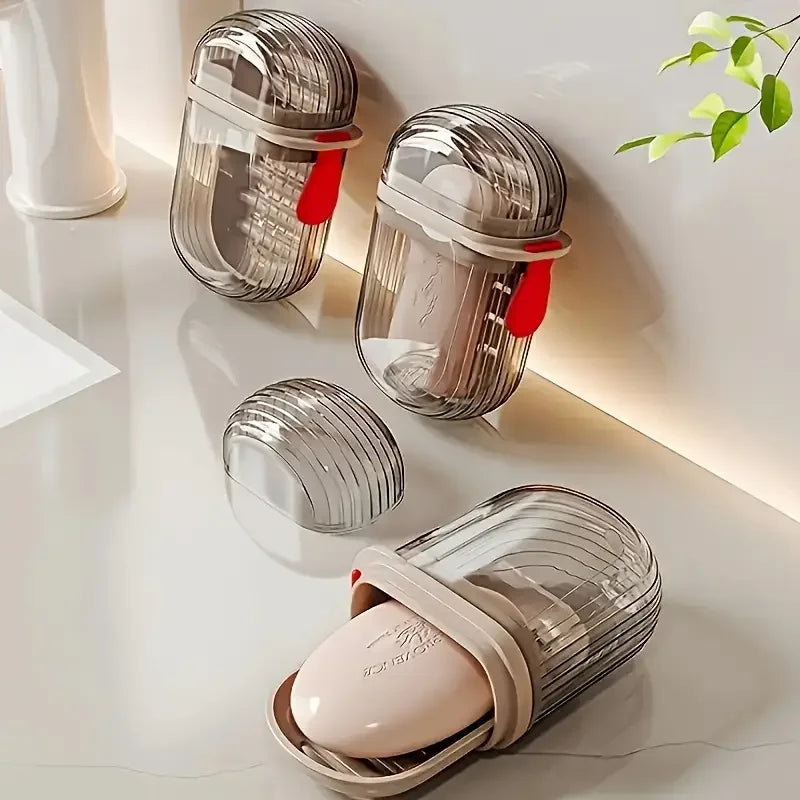 A collection of clear glass portable travel soap boxes with drainage lids and pink soap inside, displayed on a white surface.