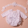 A delicate pink lace newborn princess tutu dress romper with a matching headband displayed on a neutral background.