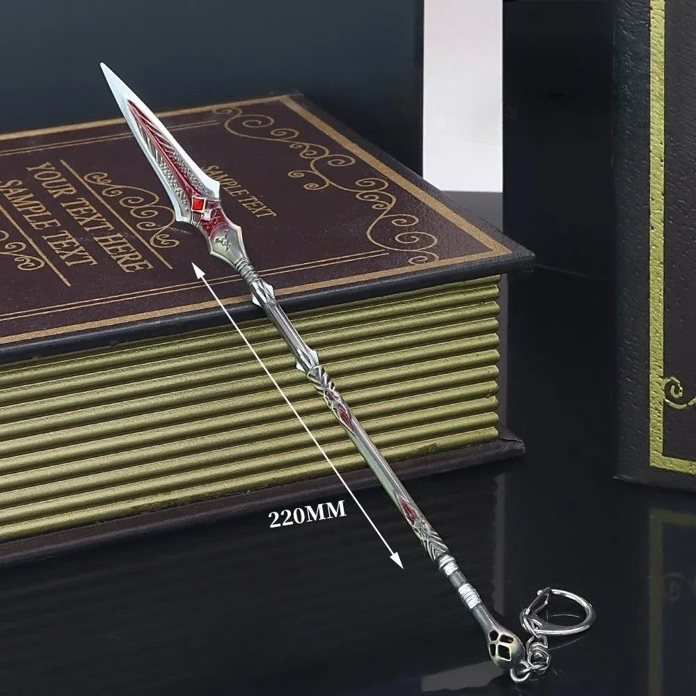A detailed metal sword keychain with a sharp point and decorative hilt rests on a stack of books.