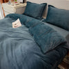 A dark teal flannel duvet cover with a zipper is displayed on a bed, surrounded by matching pillows.