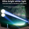 A bright white spotlight mode flashlight beams a powerful light across a dark body of water and surrounding forest.