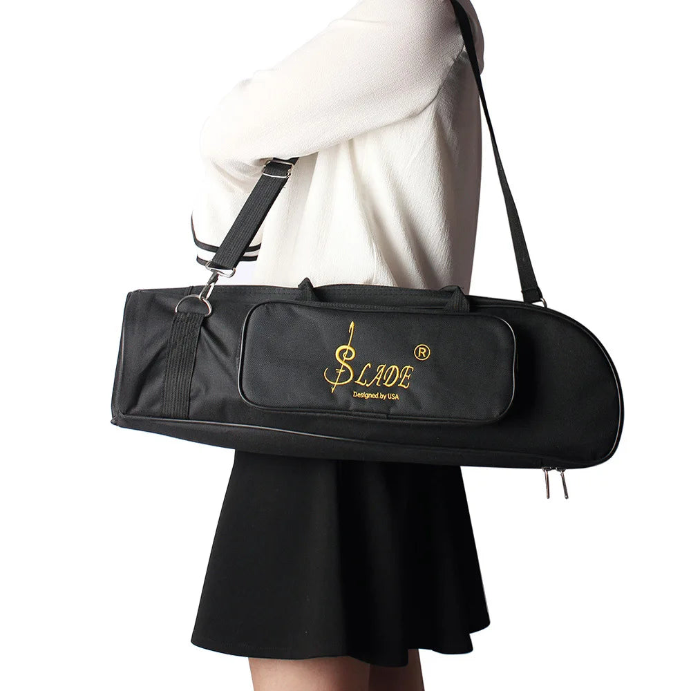 A black Slade trumpet bag is carried by a person wearing a white top and a black skirt.