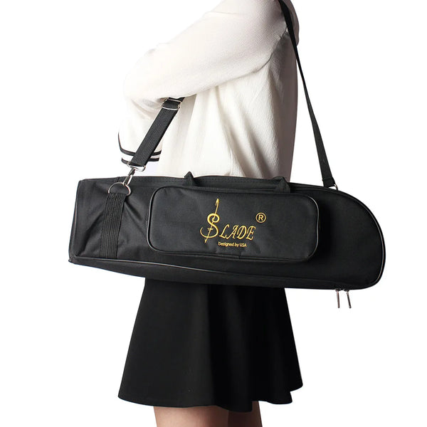 A black Slade trumpet bag is carried by a person wearing a white top and a black skirt.