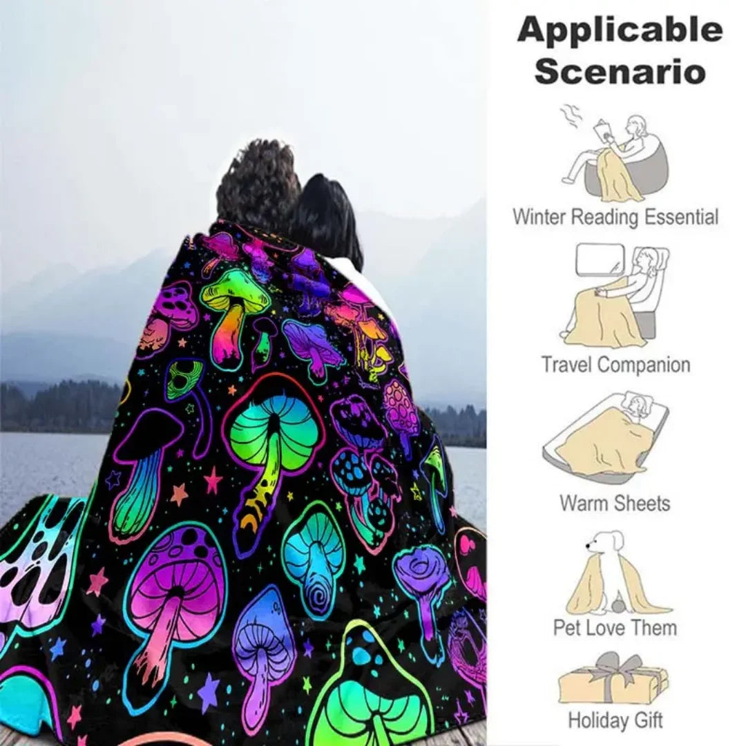 A colorful mushroom print flannel throw blanket is displayed against a snowy mountain background.