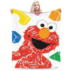 A person is holding a colorful illustration of an angry-looking bird on a white blanket.