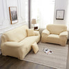 A light beige silky soft stretchable sofa cover for pets is displayed on a modern living room floor.