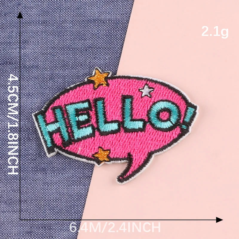 Pink embroidered lettering patch shaped like a speech bubble with the word HELLO in teal and pink thread