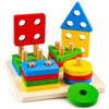 A set of colorful wooden sorting and stacking toys including a red, yellow, and blue pyramid tower and green discs.