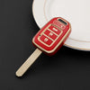 A red TPU key fob cover with a metal blade is placed on a white plate.