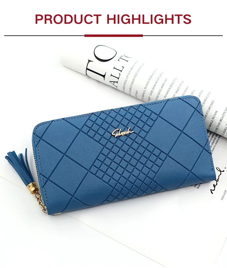 A navy blue quilted PU leather wristlet clutch wallet with a gold chain detail and tassel on a white background.
