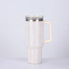 A clear tumbler with a silver lid and straw, featuring a sparkly iridescent rhinestone pattern on the body.