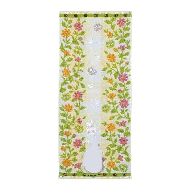 A vertical hand towel featuring a light green background with embroidered floral patterns and a central vertical stripe.