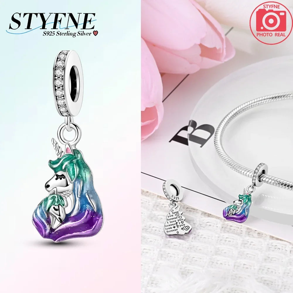 Silver pendant featuring a unicorn pegasus charm with sparkling rainbow crystals and a diamond-cut bail.