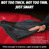 A dark gray microfiber drying towel is shown draped over a red vehicle surface.