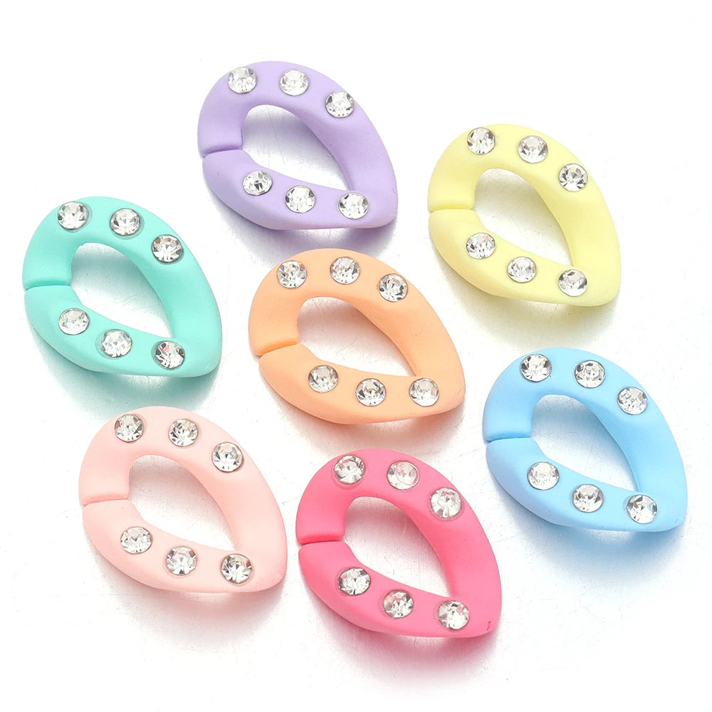 A set of acrylic jewelry connector clasps in various pastel colors, including purple, yellow, mint green, and pink.