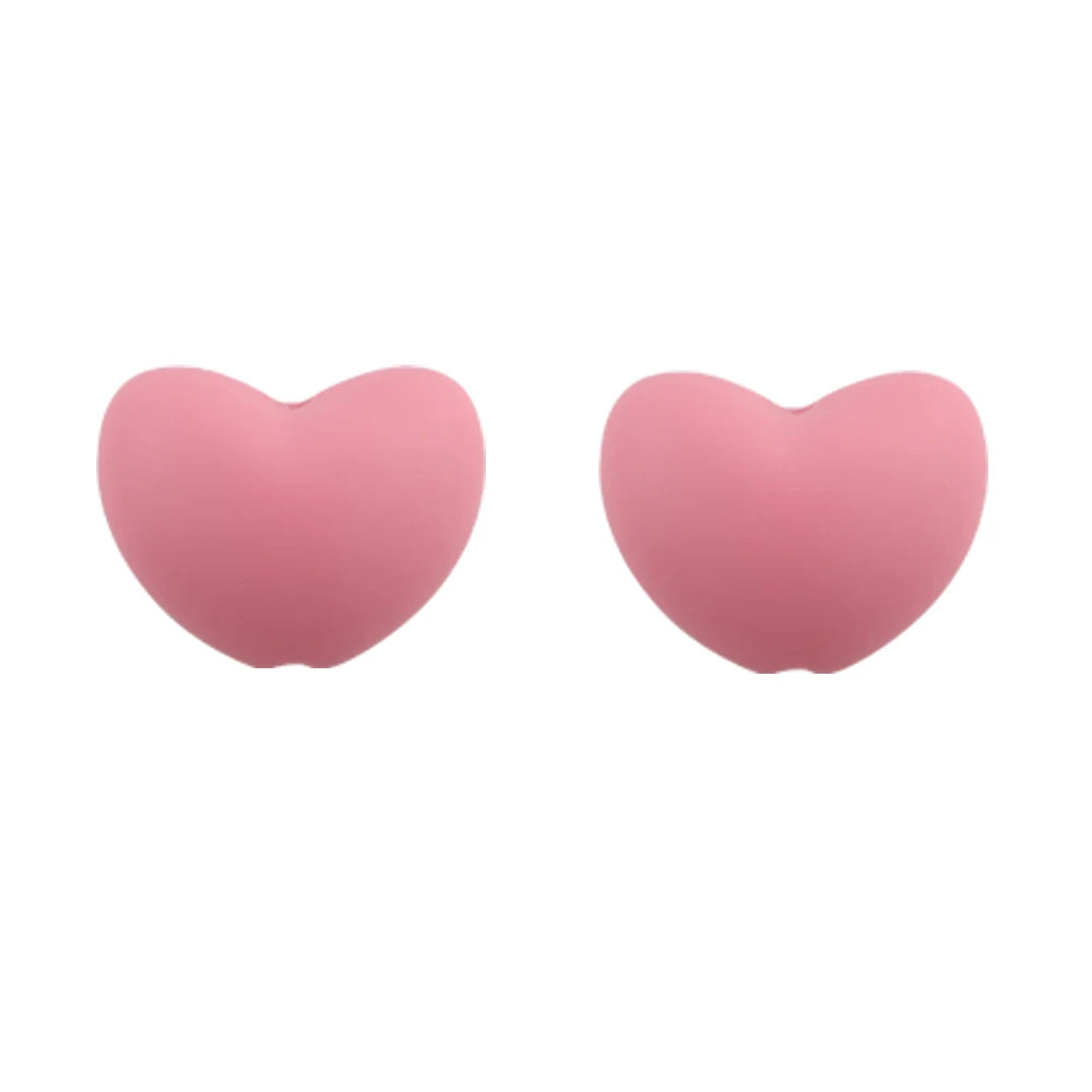 A pair of pink silicone heart beads used for DIY jewelry making.