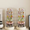 A pair of clear, rotating display cases filled with small collectible figures and keepsakes.