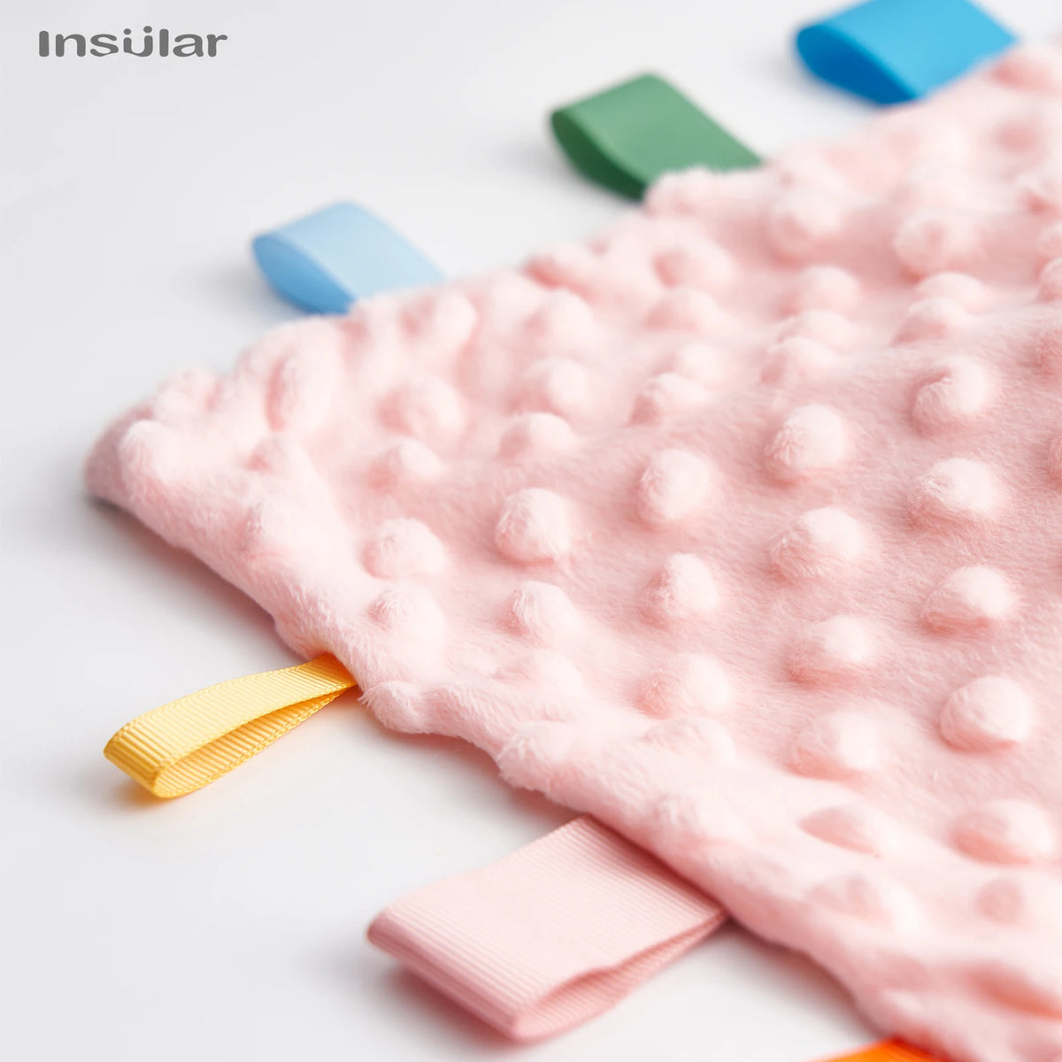Pink baby sensory tag comfort blanket with soft texture and yellow ribbon