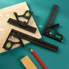 A black multifunctional carpenter square with an angle level and protractor is shown on a wooden surface.