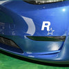 Close-up of a blue car body featuring a white R star decal on the hood.
