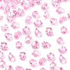 Pink acrylic crushed ice gems scattered on a white background for vase fillers and decor