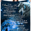 A dark blue blanket featuring a wolf silhouette and text encouraging strength and confidence for a son