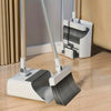 A white 3-in-1 folding broom and dustpan set with an aluminum handle resting on a wooden floor.