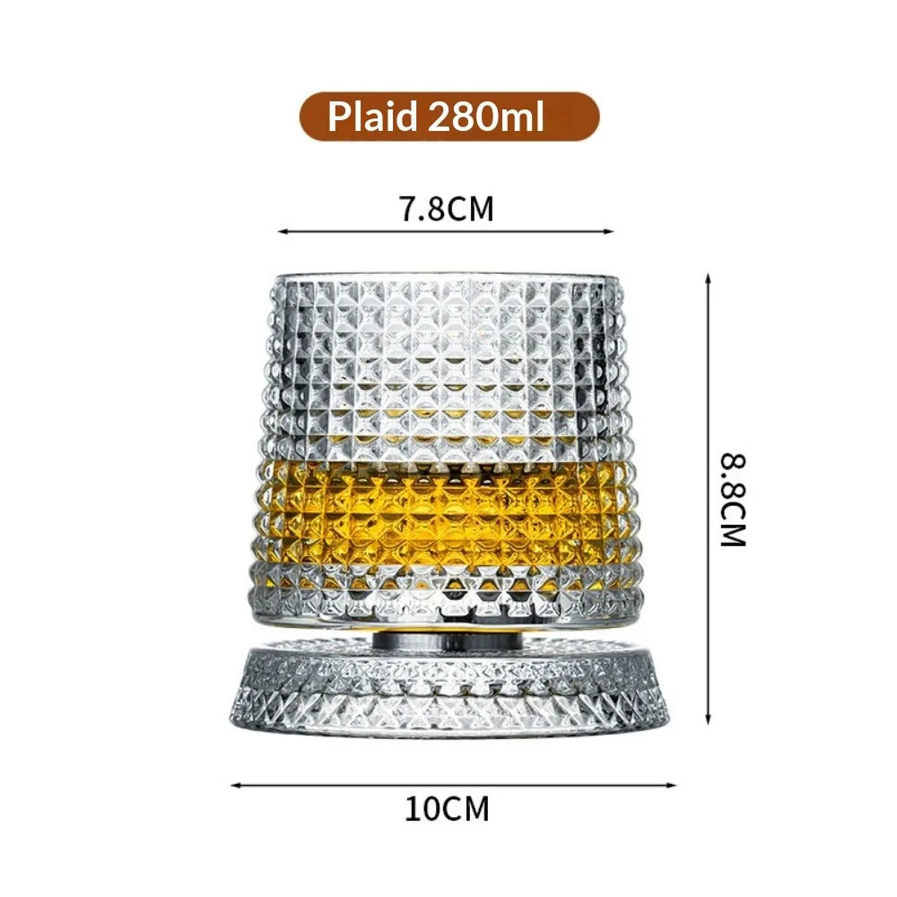 A clear crystal whiskey tumbler with a textured pattern and a decorative base.