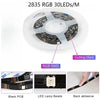 A roll of 2835 RGB 30LEDs/M SMD LED strip lights with black PCB and back adhesive.